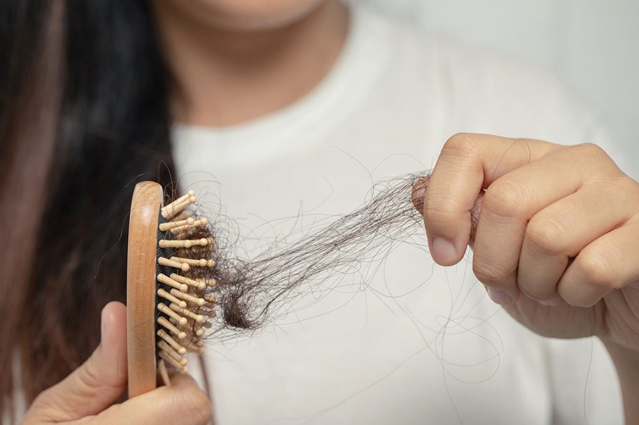 Discovering hair loss after brushing hair.